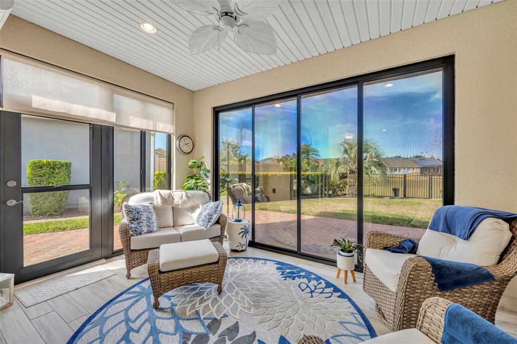 115 Bayou Bend Road Groveland, FL 34736 - Photo 20 of 47 a living room with furniture and a floor to ceiling window