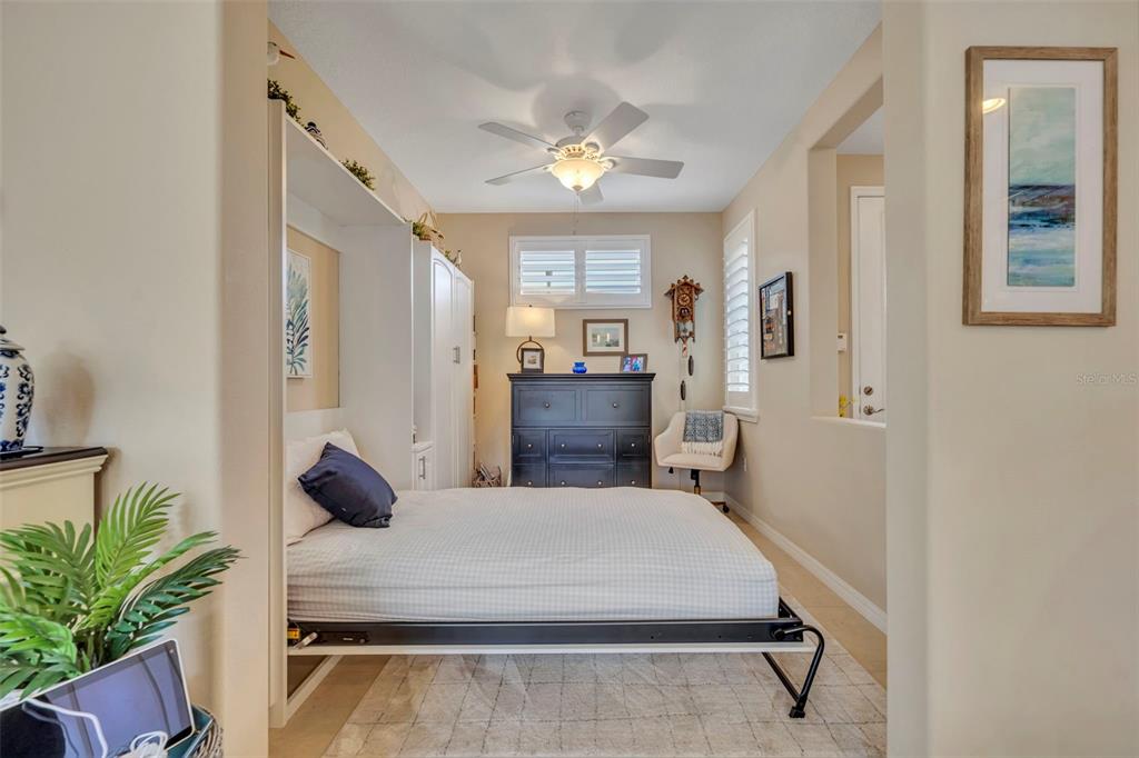 115 Bayou Bend Road Groveland, FL 34736 - Photo 22 of 47 a room with a bed and potted plant with view of living room