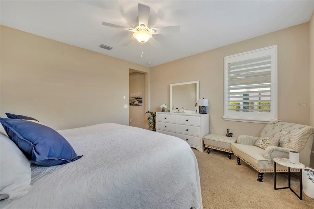 115 Bayou Bend Road Groveland, FL 34736 - Photo 25 of 47 a spacious bedroom with a bed and a couch