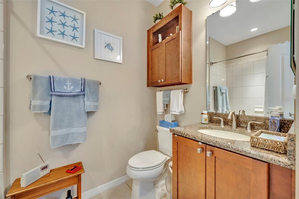 115 Bayou Bend Road Groveland, FL 34736 - Photo 29 of 47 a bathroom with a granite countertop toilet sink and mirror