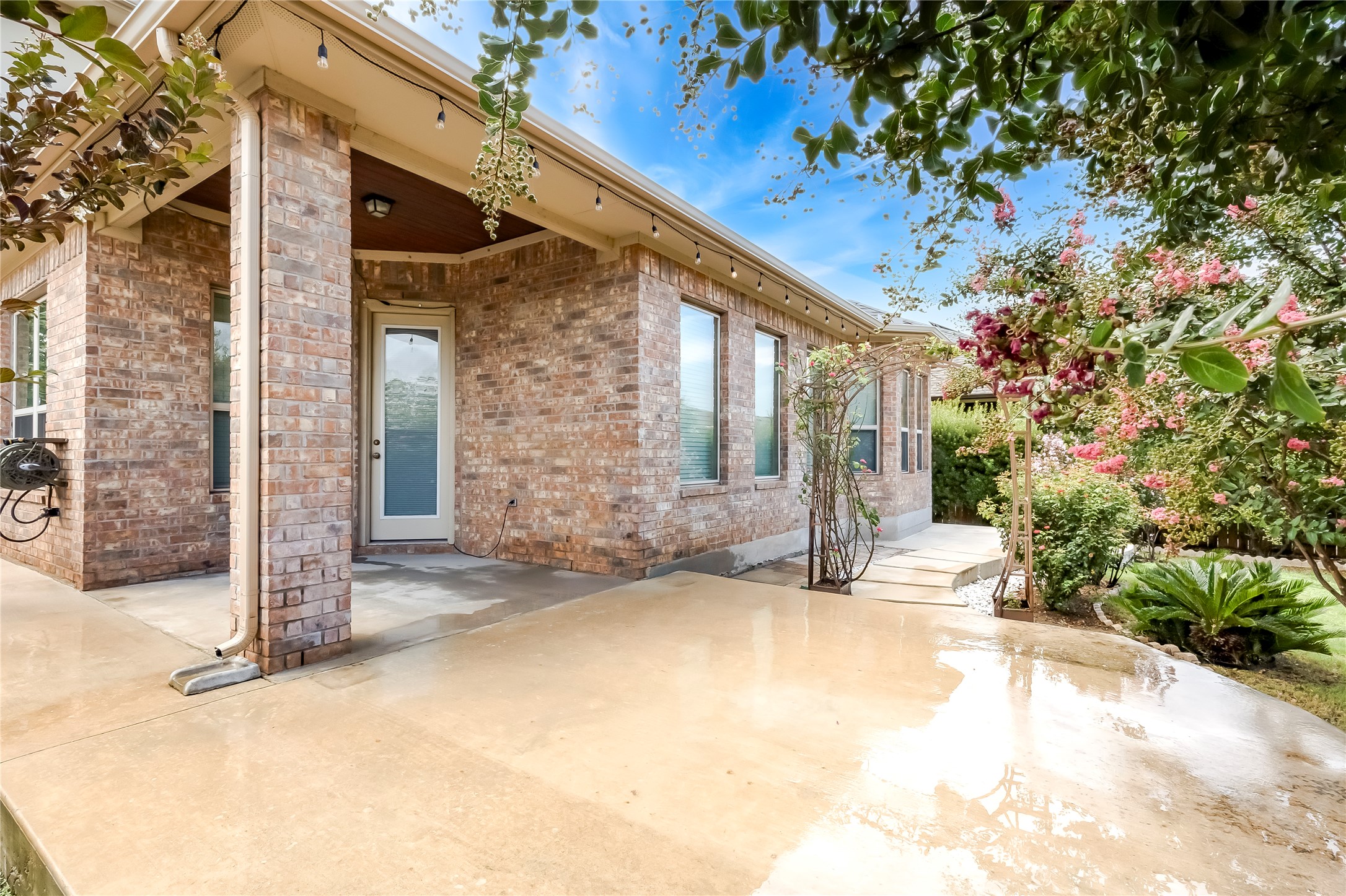 345 Fort Cobb Way Georgetown, TX 78628 - Photo 38 of 38 A spacious concrete patio extends along the brick exterior of this home.
