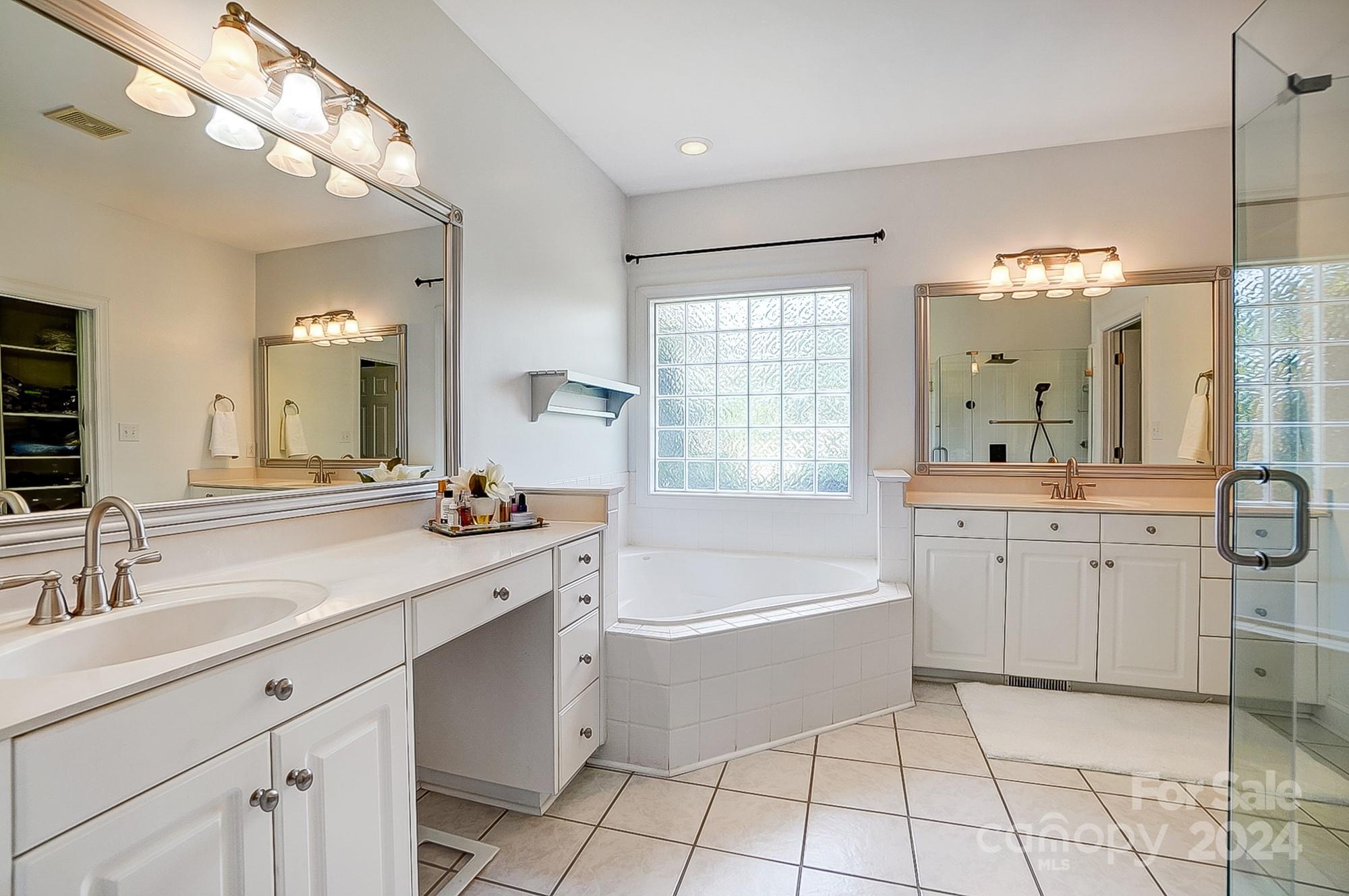 814 Pine Forest Road Charlotte, NC 28214 - Photo 13 of 26 a spacious bathroom with a double vanity sink mirror and bathtub