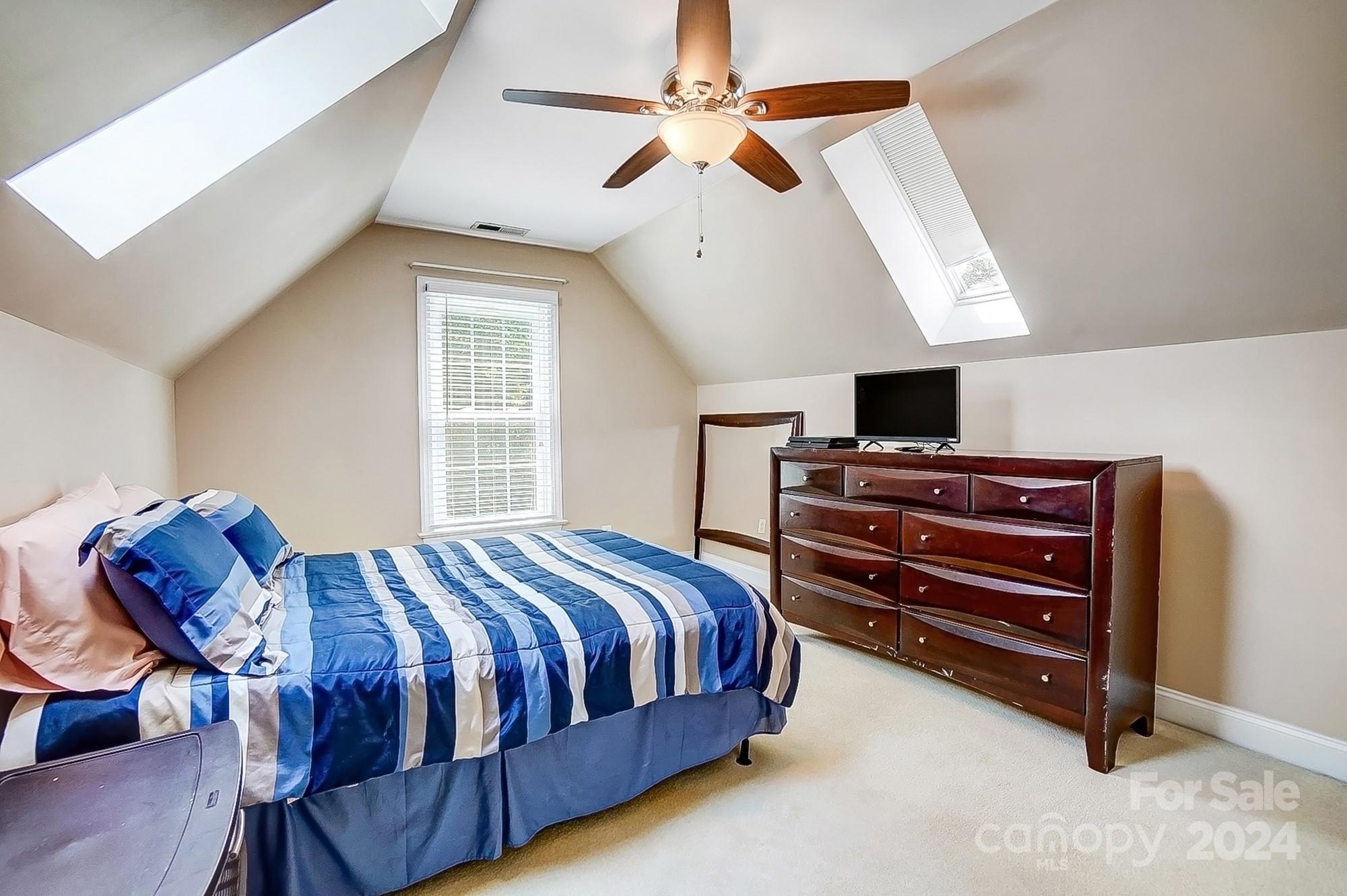 814 Pine Forest Road Charlotte, NC 28214 - Photo 17 of 26 a bedroom with a bed and a chandelier