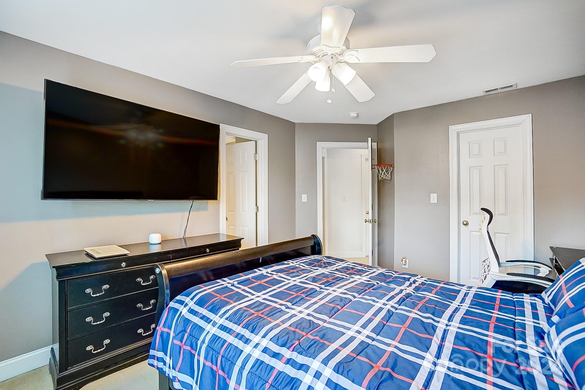 814 Pine Forest Road Charlotte, NC 28214 - Photo 19 of 26 a bedroom with a bed and a flat screen tv