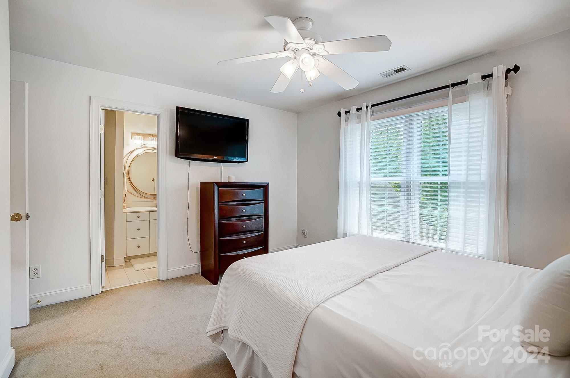 814 Pine Forest Road Charlotte, NC 28214 - Photo 20 of 26 a bedroom with a bed and a flat screen tv