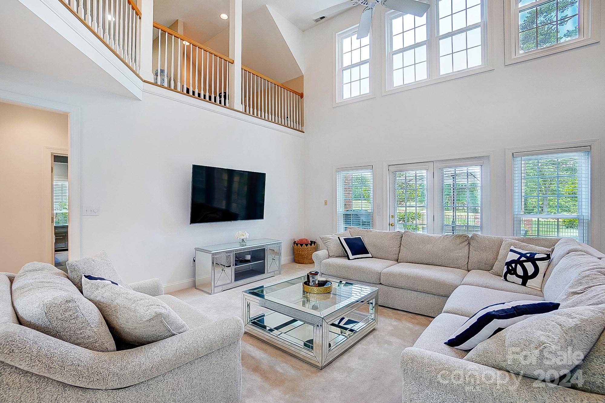 814 Pine Forest Road Charlotte, NC 28214 - Photo 2 of 26 a living room with furniture a flat screen tv and a large window