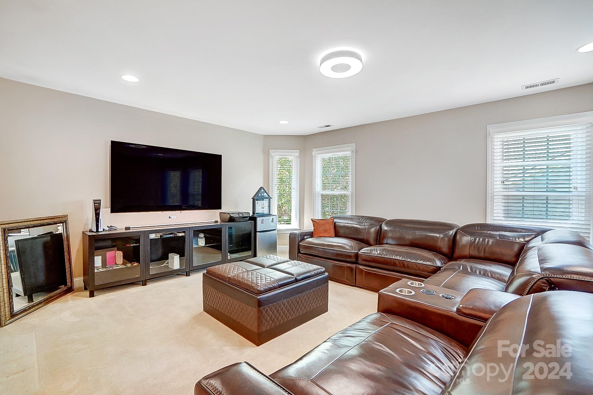 814 Pine Forest Road Charlotte, NC 28214 - Photo 22 of 26 a living room with furniture and a flat screen tv