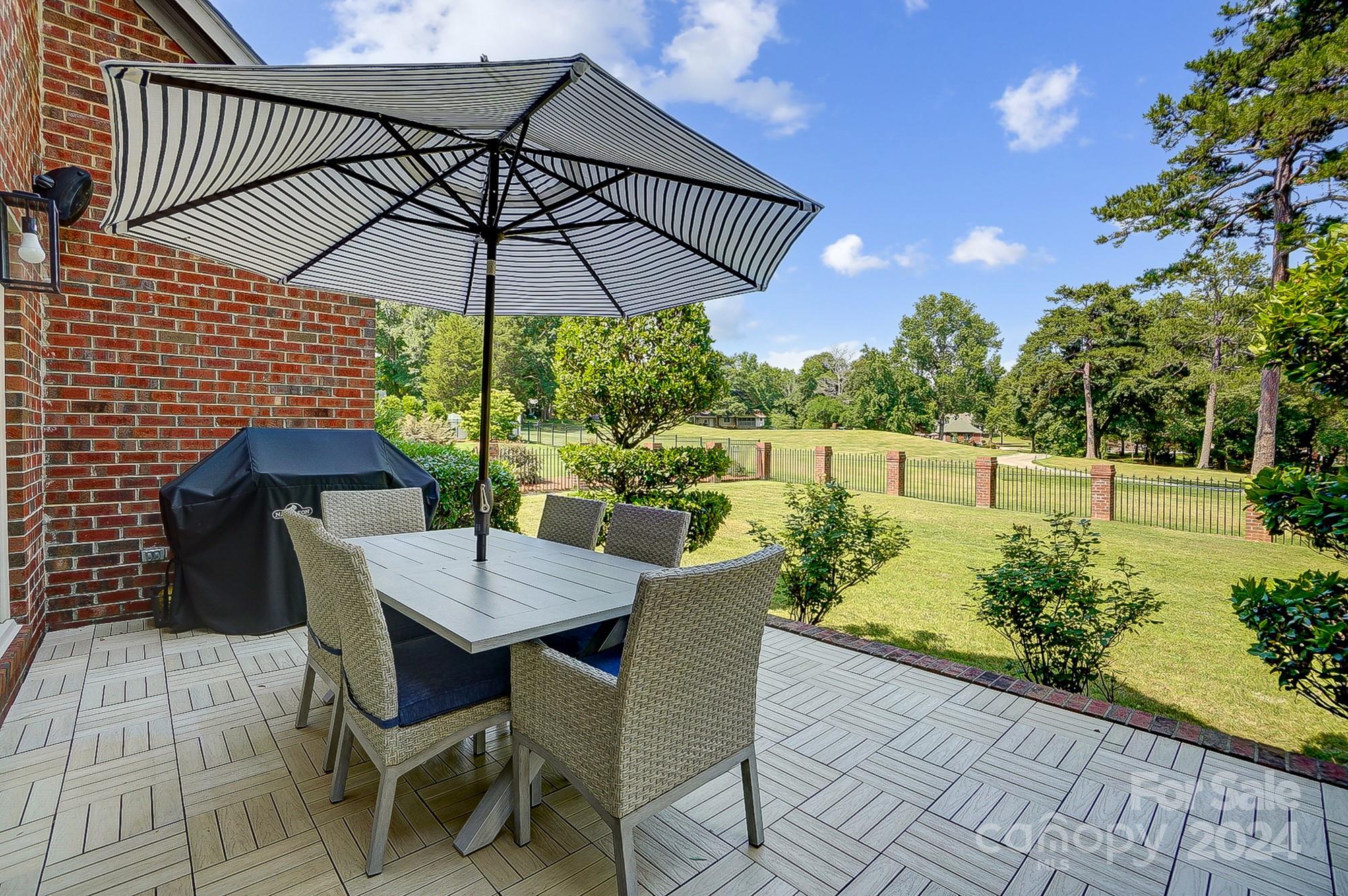 814 Pine Forest Road Charlotte, NC 28214 - Photo 23 of 26 a view of an outdoor sitting area with furniture and umbrella