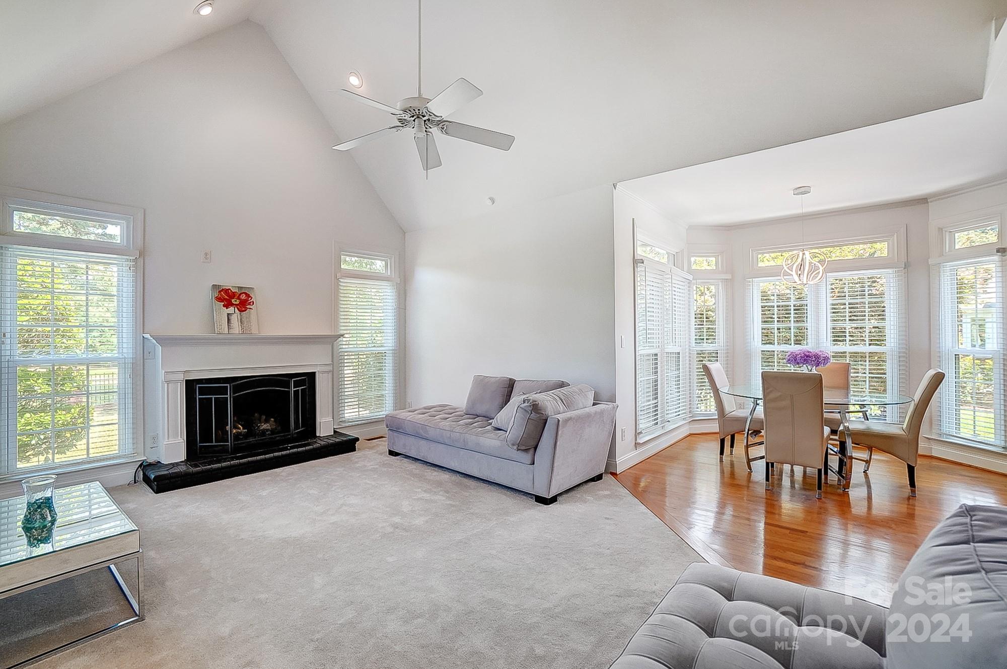 814 Pine Forest Road Charlotte, NC 28214 - Photo 5 of 26 a living room with furniture a fireplace and a large window