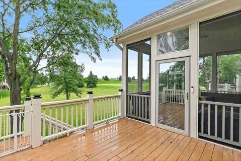 a view of a wooden deck with a big yard