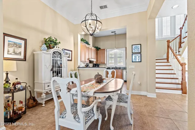 a view of a dining room with furniture and a chandelier