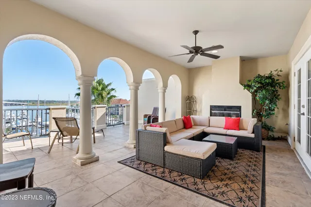 a living room with furniture a chandelier and a rug