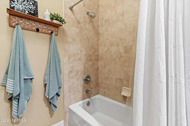 a bathroom with a tub and shower