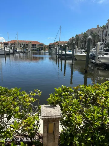 a view of a lake with boats and trees in the background
