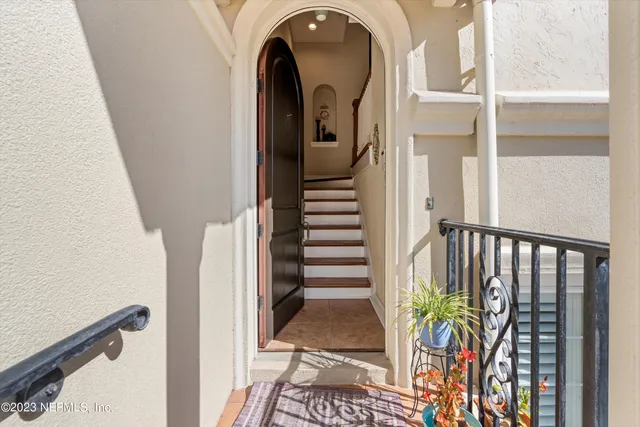a view of a hallway with wooden floor and stairs