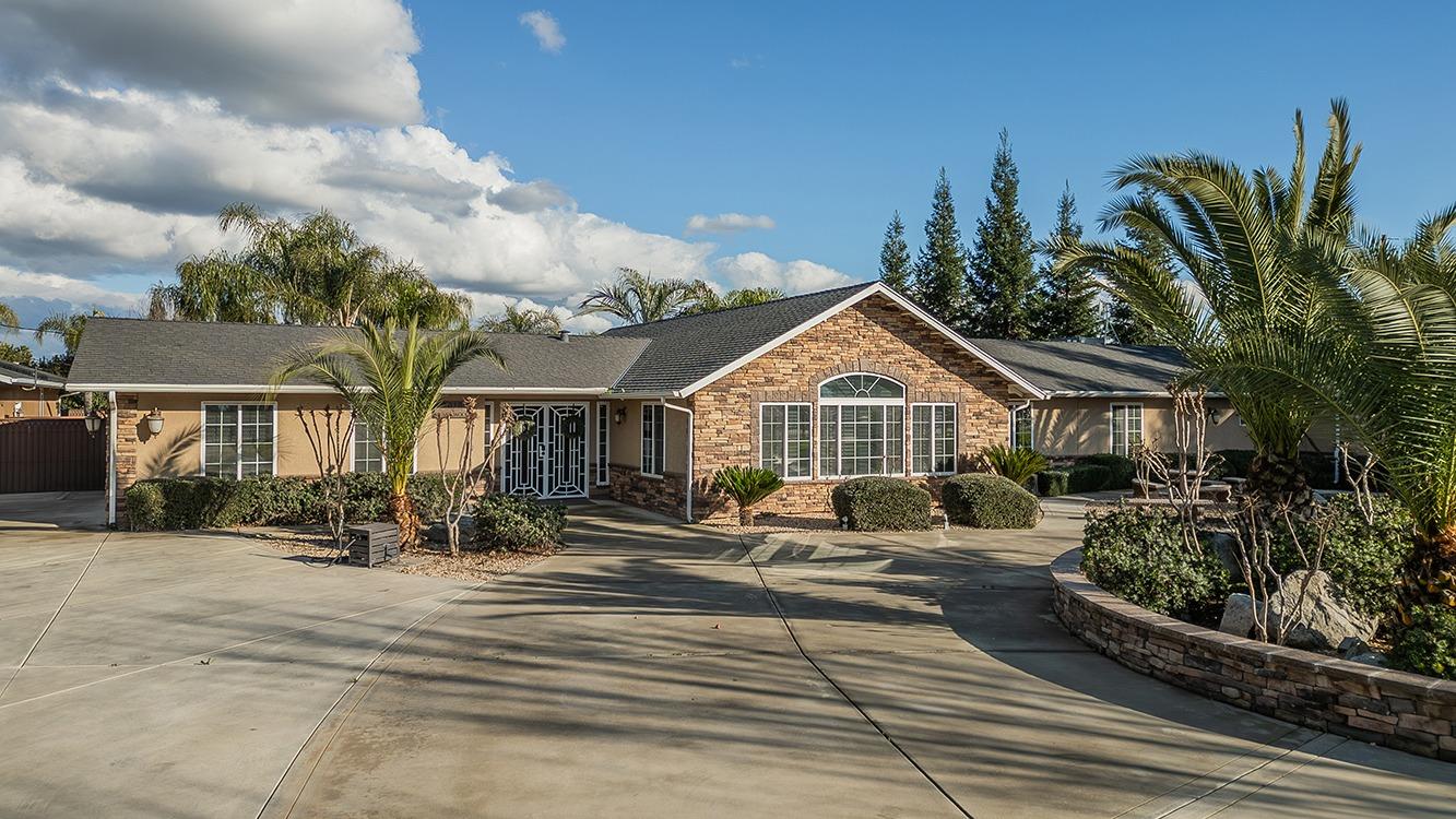 a front view of house with yard outdoor seating and barbeque oven