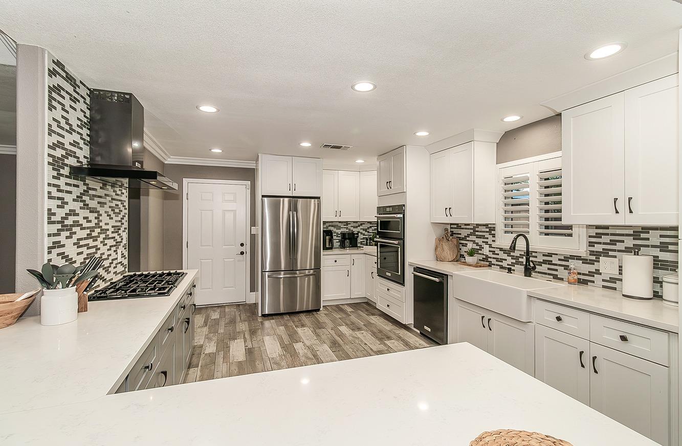 7010 South Frankwood Avenue Reedley, CA 93654 - Photo 12 of 75 a kitchen with stainless steel appliances kitchen island granite countertop a refrigerator and a sink