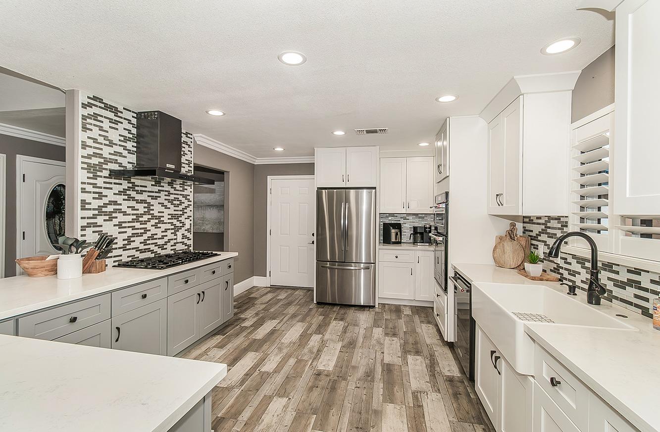 7010 South Frankwood Avenue Reedley, CA 93654 - Photo 13 of 75 a kitchen with refrigerator and cabinets