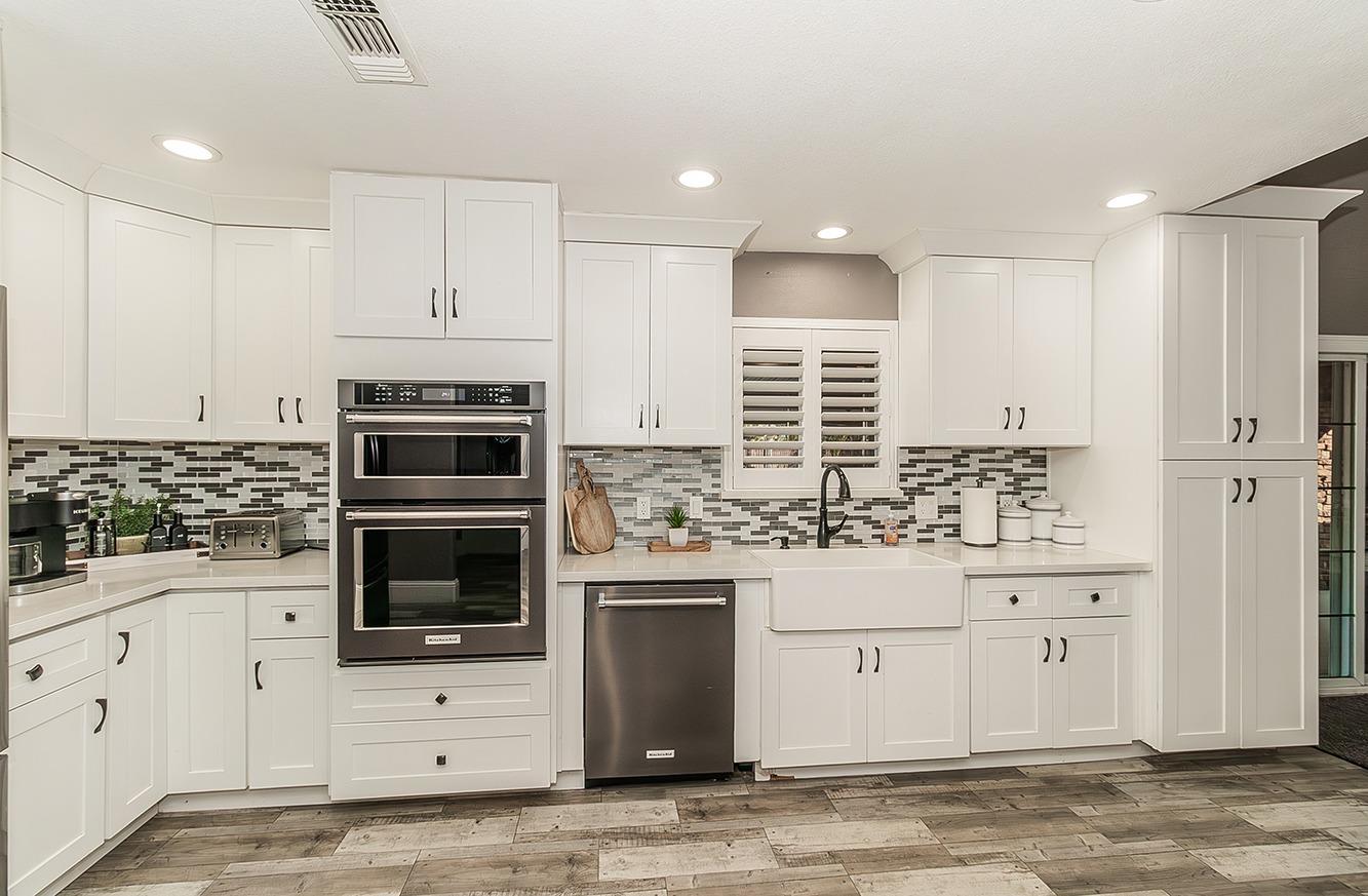 7010 South Frankwood Avenue Reedley, CA 93654 - Photo 15 of 75 a kitchen with stainless steel appliances kitchen island granite countertop a stove and a sink