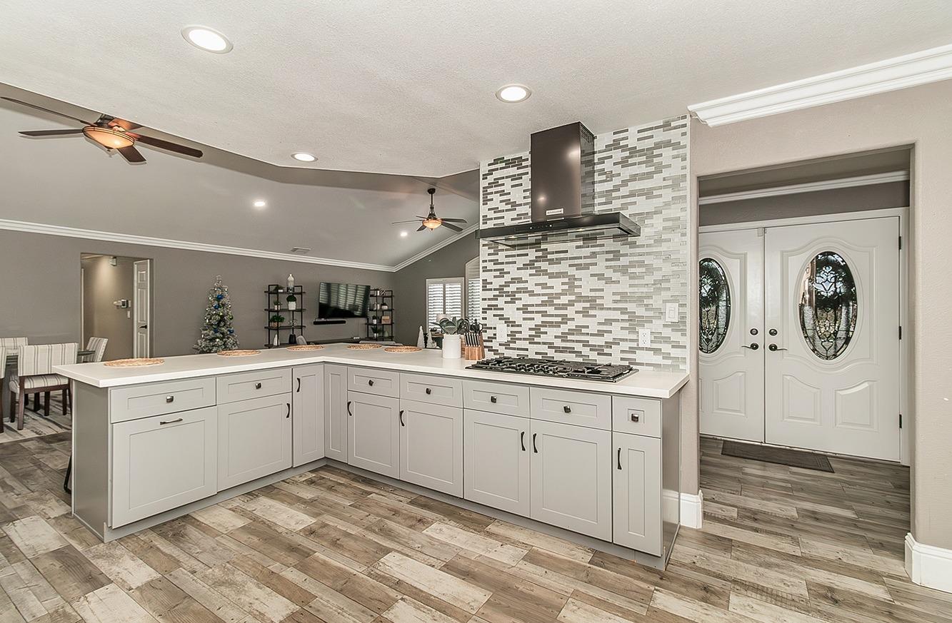 7010 South Frankwood Avenue Reedley, CA 93654 - Photo 16 of 75 a spacious bathroom with a sink a mirror and a bathtub