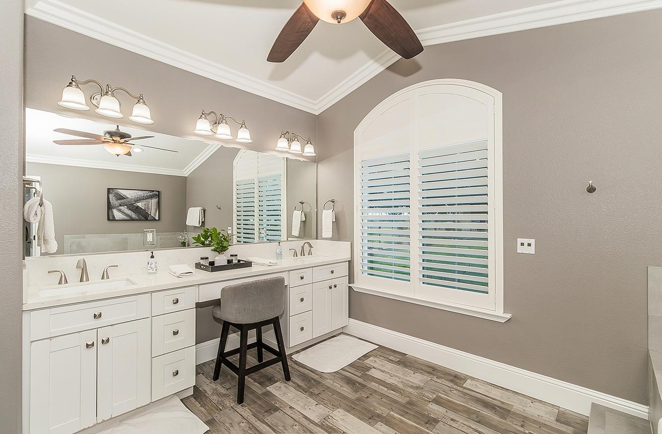 7010 South Frankwood Avenue Reedley, CA 93654 - Photo 22 of 75 a spacious bathroom with a granite countertop sink a large mirror and a window