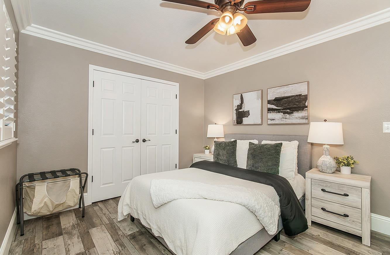 7010 South Frankwood Avenue Reedley, CA 93654 - Photo 26 of 75 a bedroom with a bed and a ceiling fan
