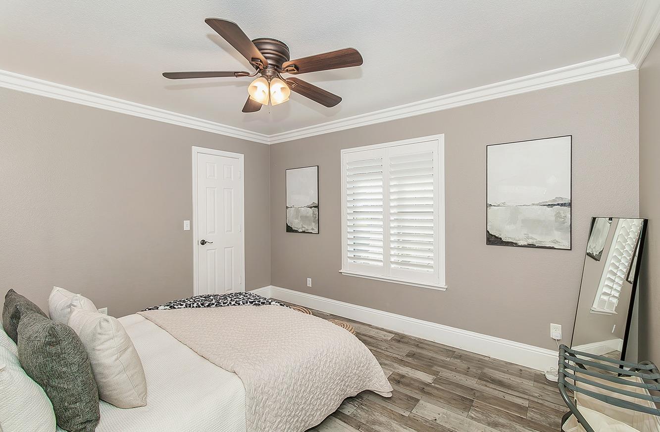 7010 South Frankwood Avenue Reedley, CA 93654 - Photo 31 of 75 a bedroom with a large bed and a window