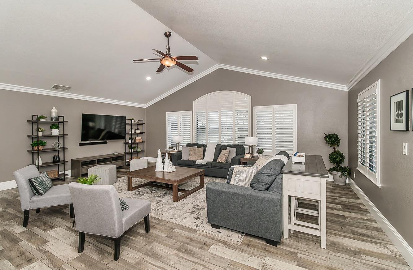 7010 South Frankwood Avenue Reedley, CA 93654 - Photo 4 of 75 a living room with furniture kitchen view and a flat screen tv