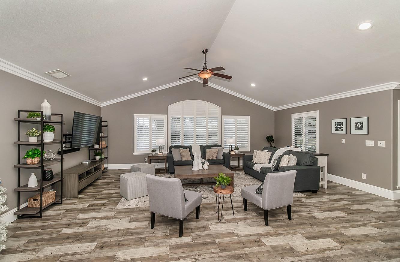 7010 South Frankwood Avenue Reedley, CA 93654 - Photo 5 of 75 a living room with fireplace furniture and a wooden floor