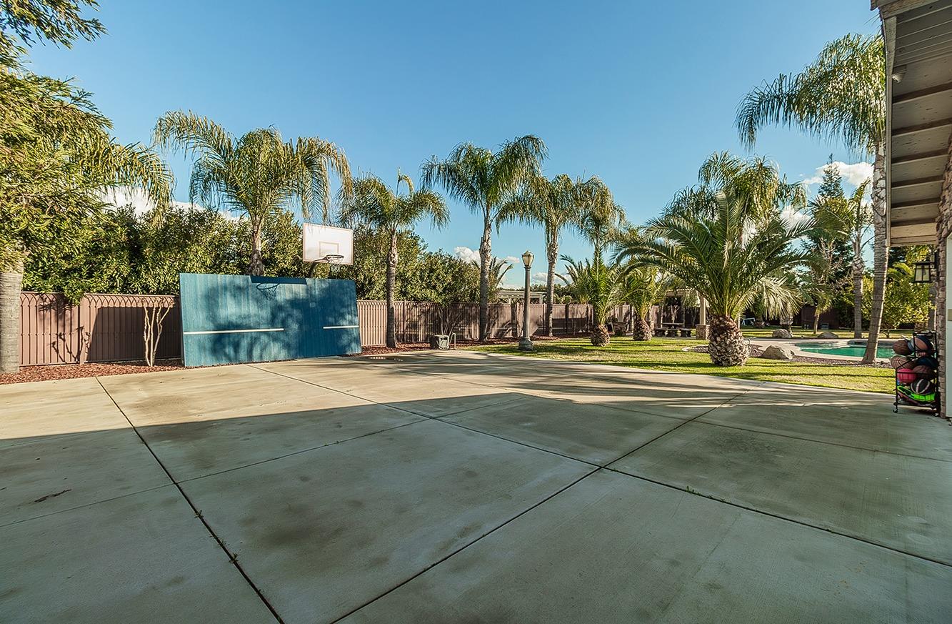 7010 South Frankwood Avenue Reedley, CA 93654 - Photo 51 of 75 a view of a playground with basketball court