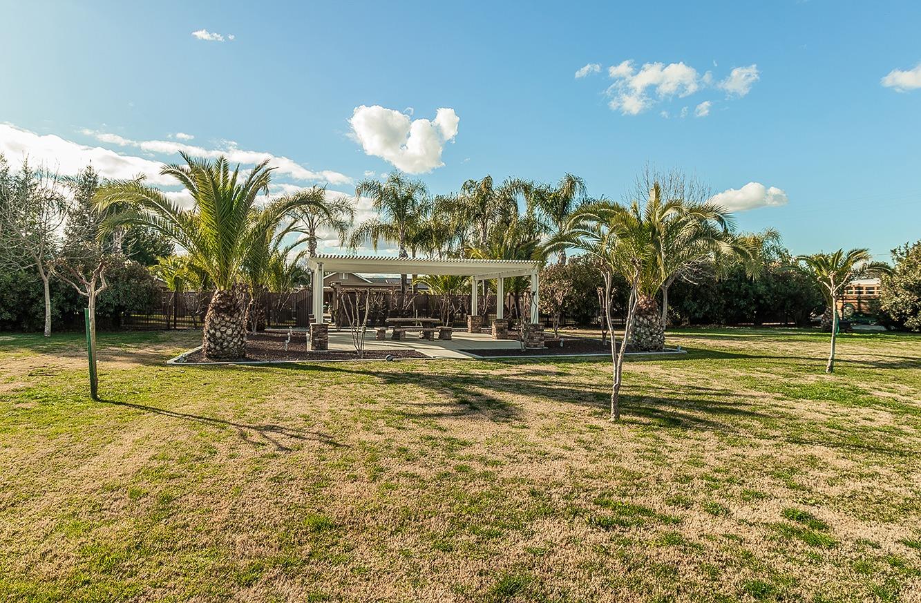 7010 South Frankwood Avenue Reedley, CA 93654 - Photo 56 of 75 a view of a swimming pool with a table and chairs