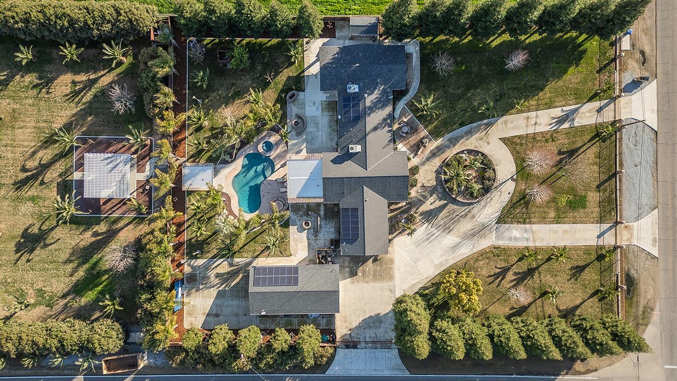 7010 South Frankwood Avenue Reedley, CA 93654 - Photo 75 of 75 an aerial view of a house with a garden and statue