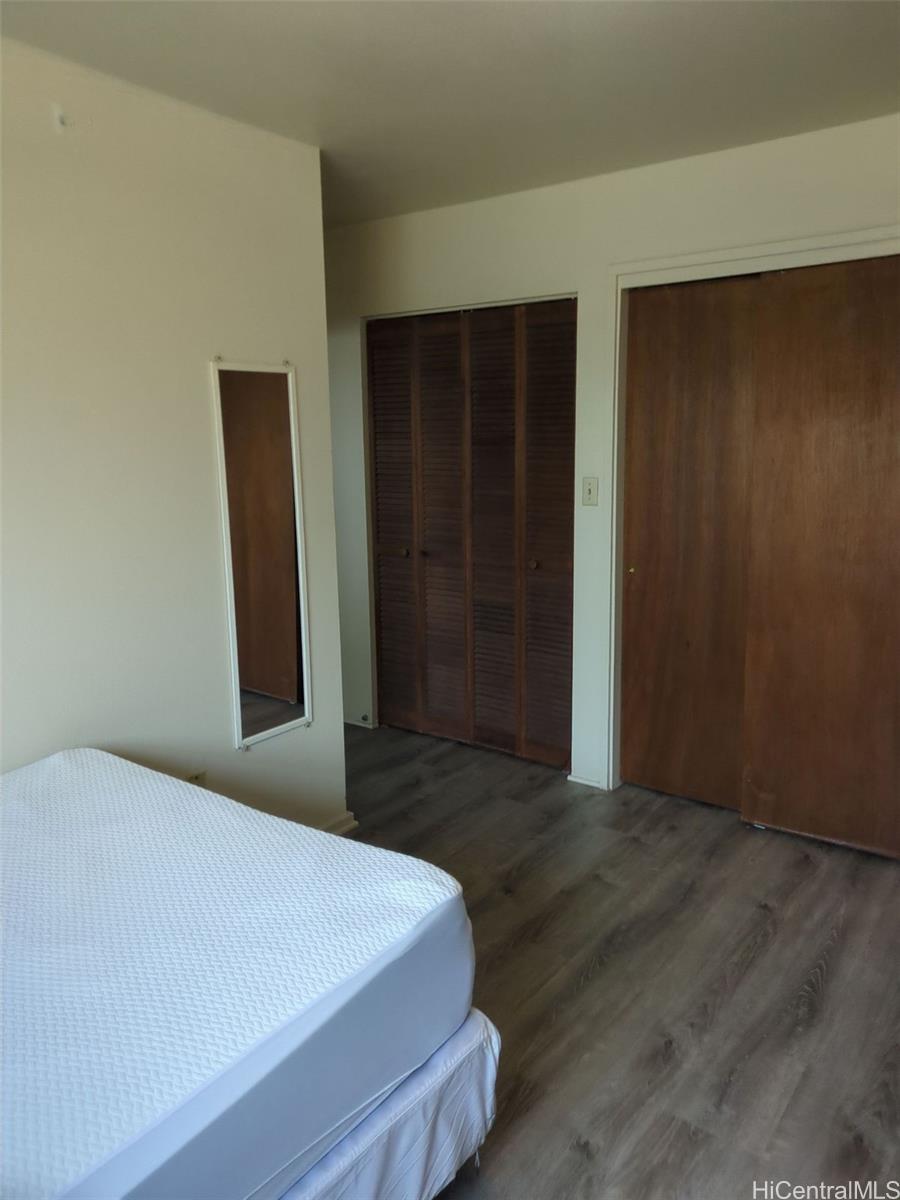 1042 17th Avenue Honolulu, HI 96816 - Photo 14 of 16 a bedroom with a bed and wooden floor