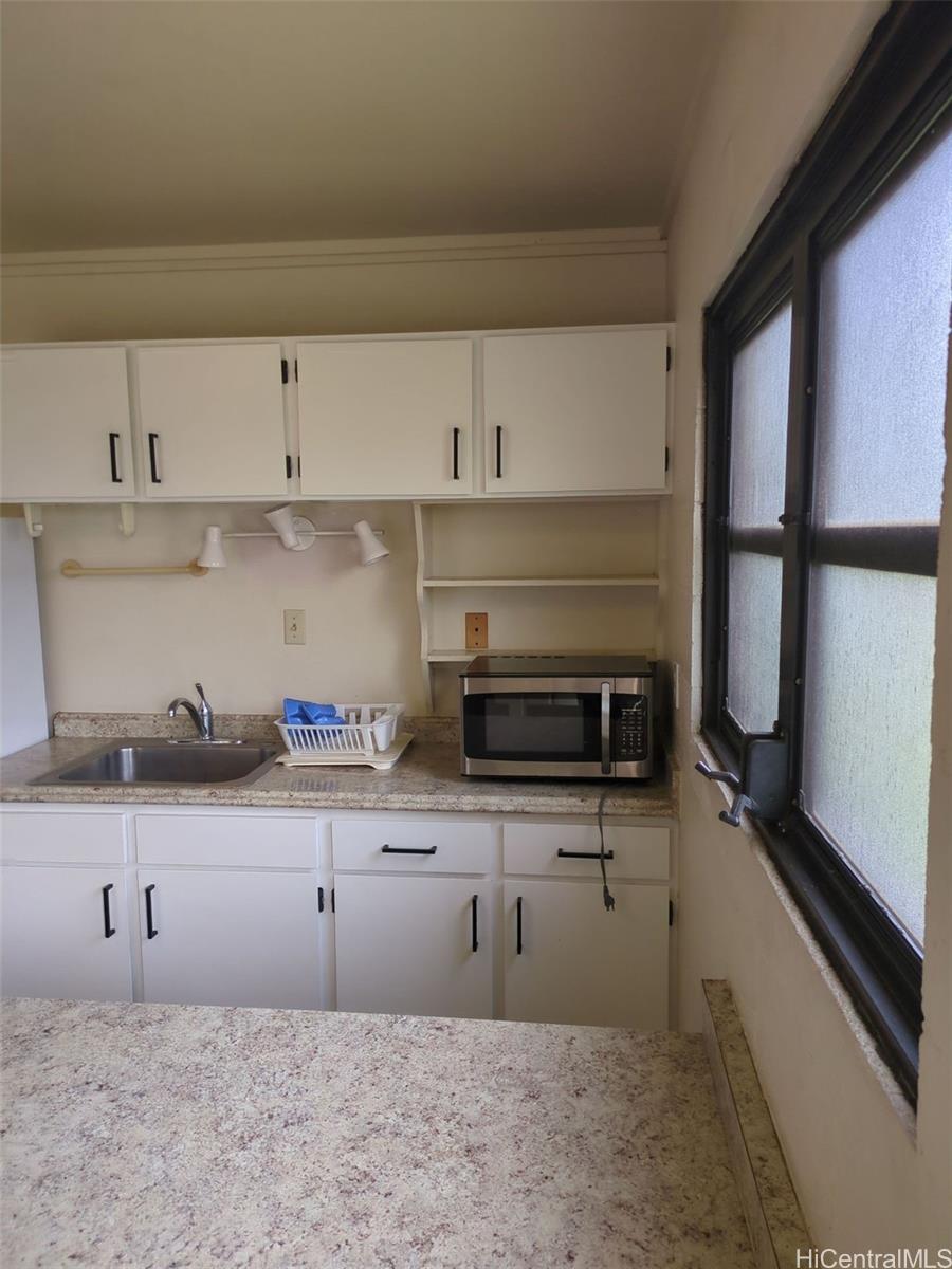 1042 17th Avenue Honolulu, HI 96816 - Photo 3 of 16 a kitchen with granite countertop a sink and a stove top oven