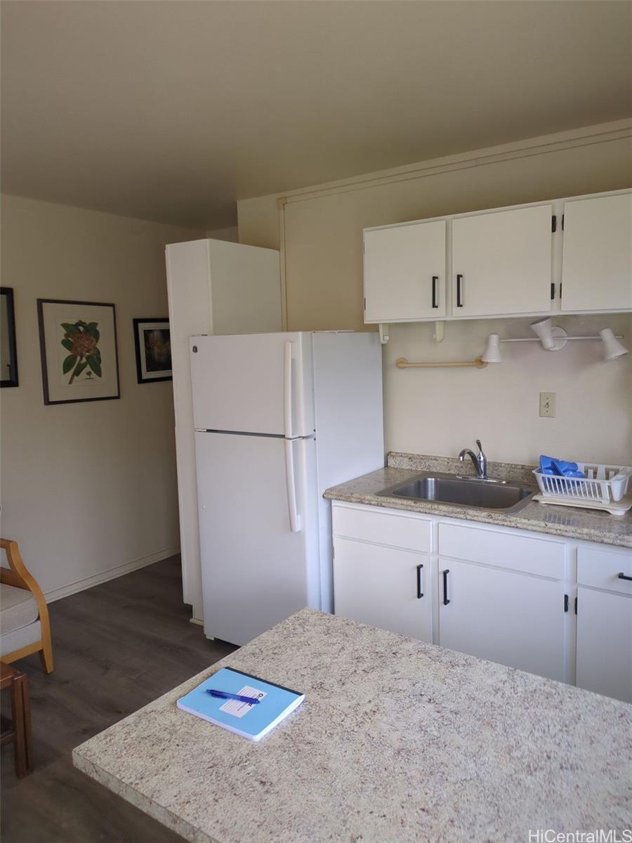 1042 17th Avenue Honolulu, HI 96816 - Photo 5 of 16 a kitchen with granite countertop a refrigerator a sink and a stove