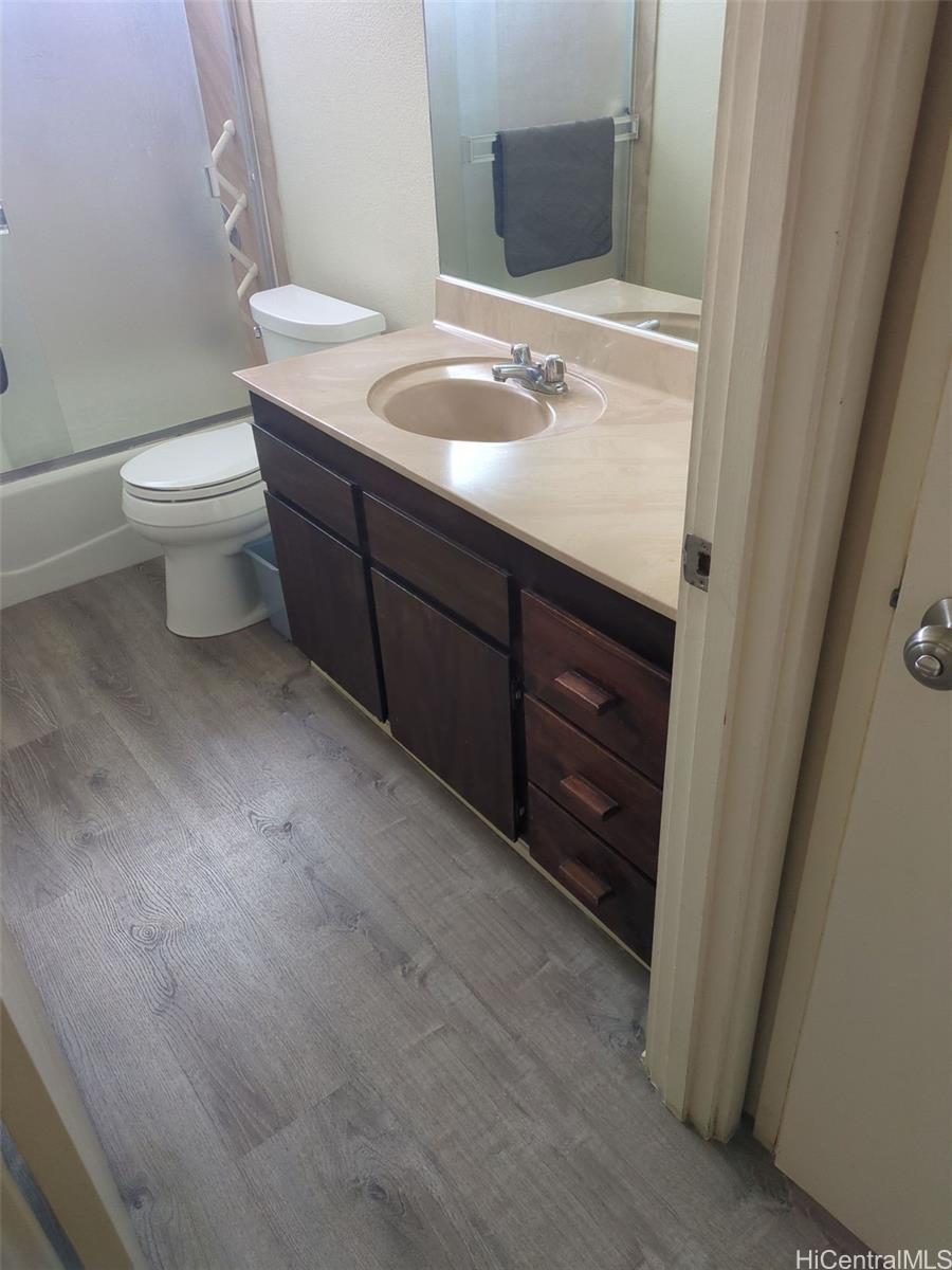 1042 17th Avenue Honolulu, HI 96816 - Photo 10 of 16 a bathroom with a sink a toilet and mirror