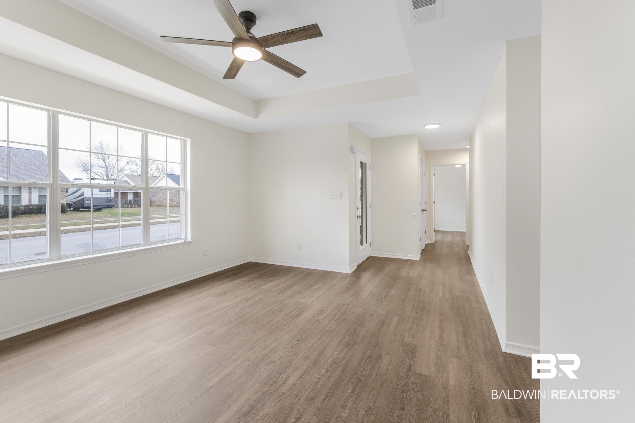 16330 Absalom Street Foley, AL 36535 - Photo 16 of 42 Unfurnished room with light hardwood / wood-style floors, a raised ceiling, and ceiling fan