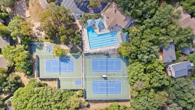 a view of a house with a yard and potted plants