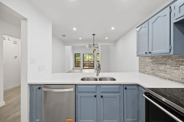 a kitchen with a sink and cabinets