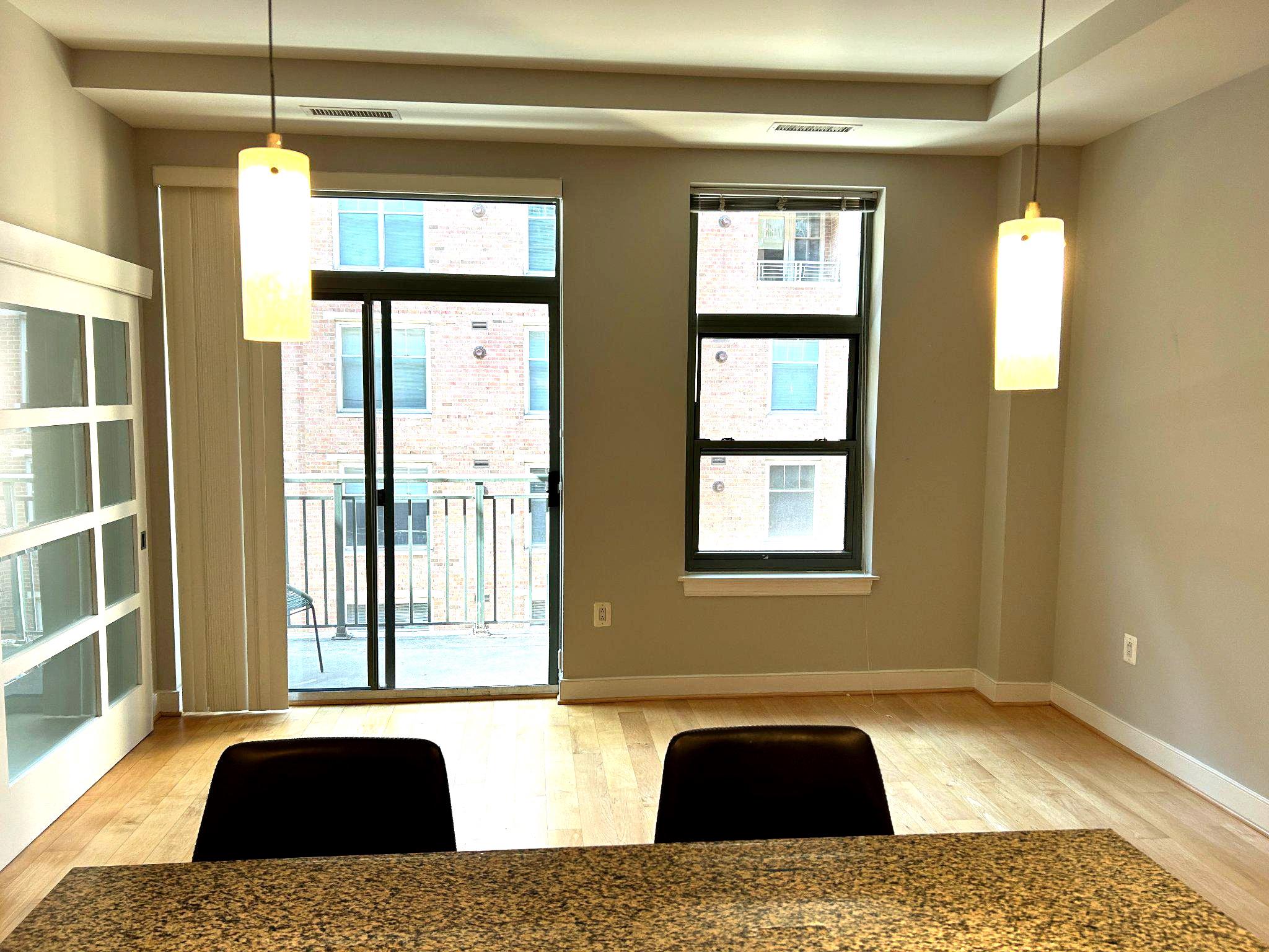 2425 L Street Northwest, Unit 421 Washington, DC 20037 - Photo 3 of 18 Bright and airy living room and blacony