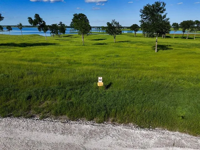 a backyard of a house with a yard and trees