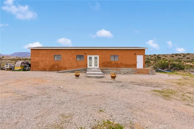 a backyard of a house with basket ball court