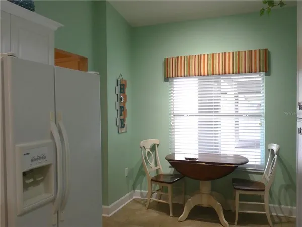 a view of a room with a window and furniture
