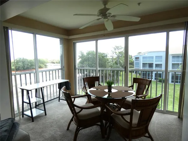 a living room with furniture and a floor to ceiling window