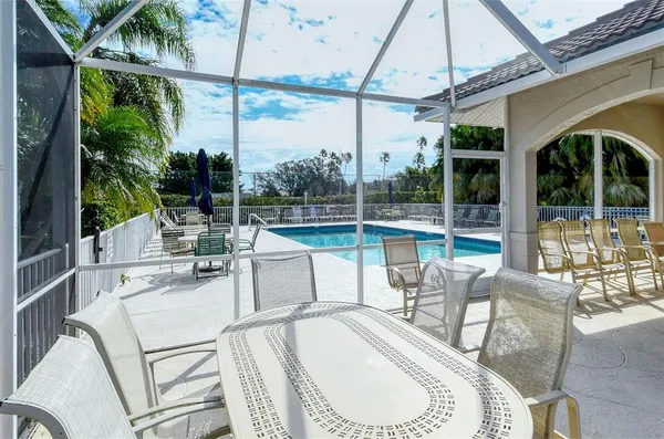 a view of a patio with couches table and chairs and potted plants