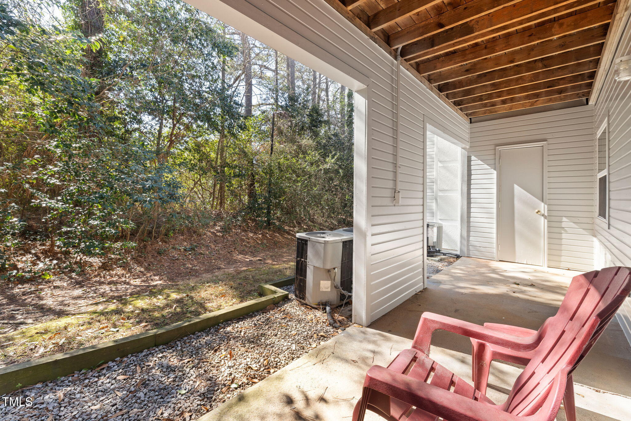 2520 Avent Ferry Road, Unit 103 Raleigh, NC 27606 - Photo 21 of 23 a view of a backyard with table and chairs and wooden fence