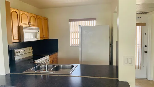 a view of a refrigerator in kitchen
