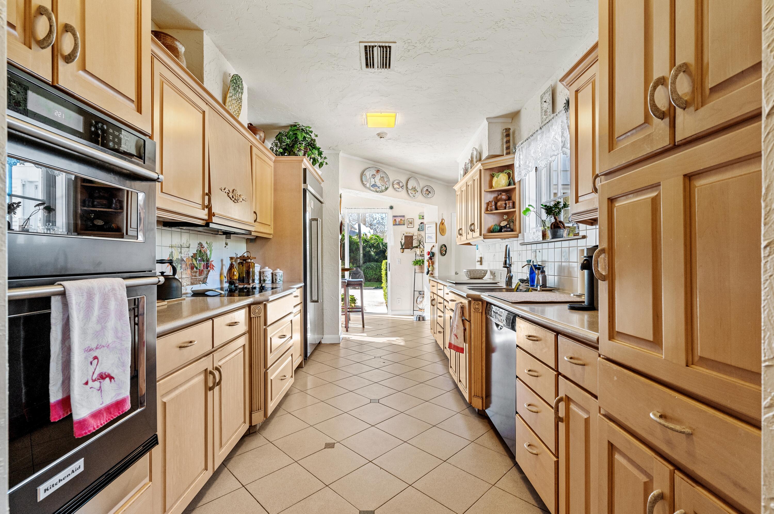 3224 North Ocean Boulevard Gulf Stream, FL 33483 - Photo 20 of 48 a large kitchen with stainless steel appliances lots of counter space and wooden floor