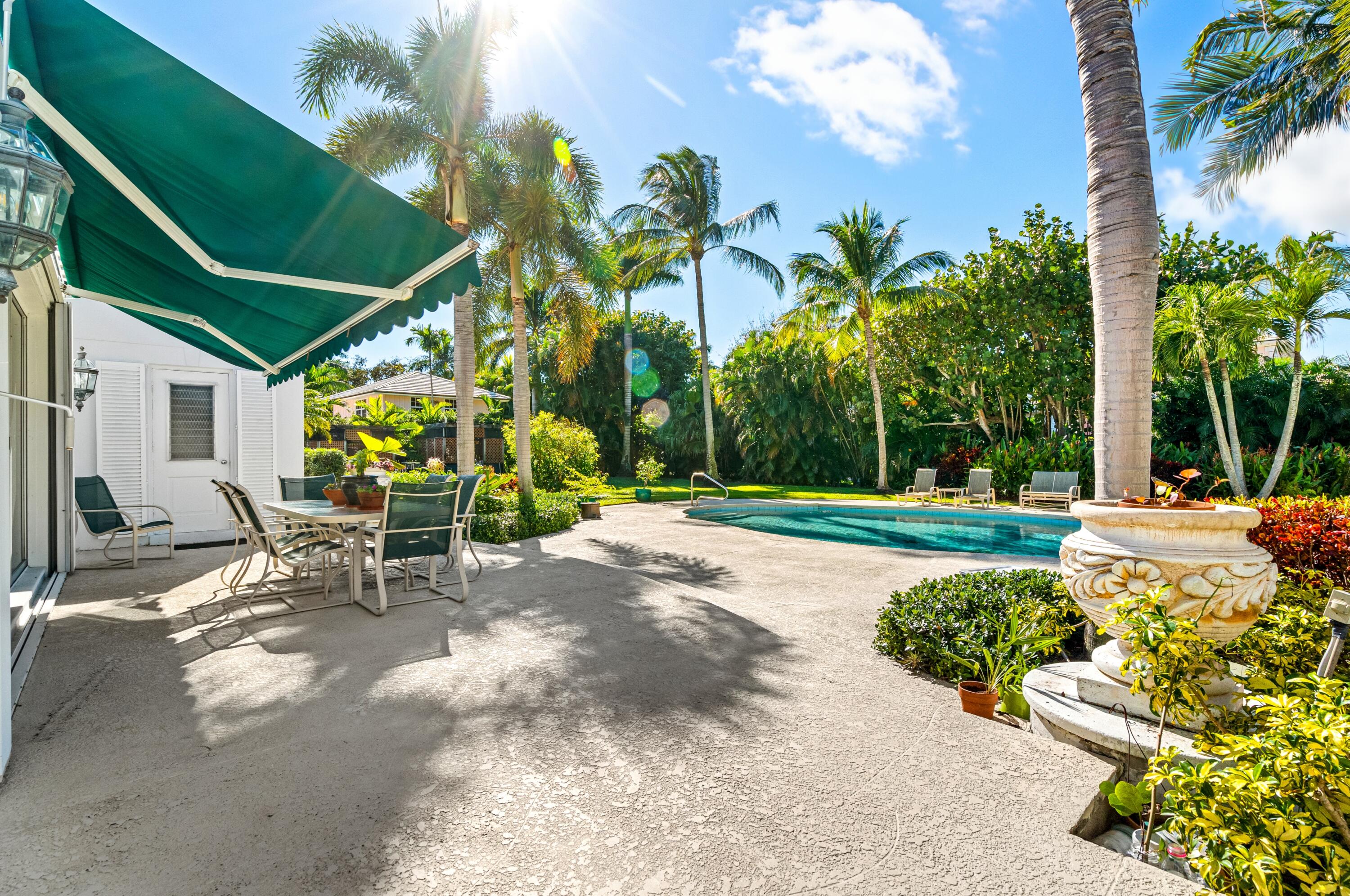 3224 North Ocean Boulevard Gulf Stream, FL 33483 - Photo 39 of 48 a view of backyard with a table and chairs and potted plants
