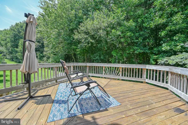 a living room with table chairs and wooden floor
